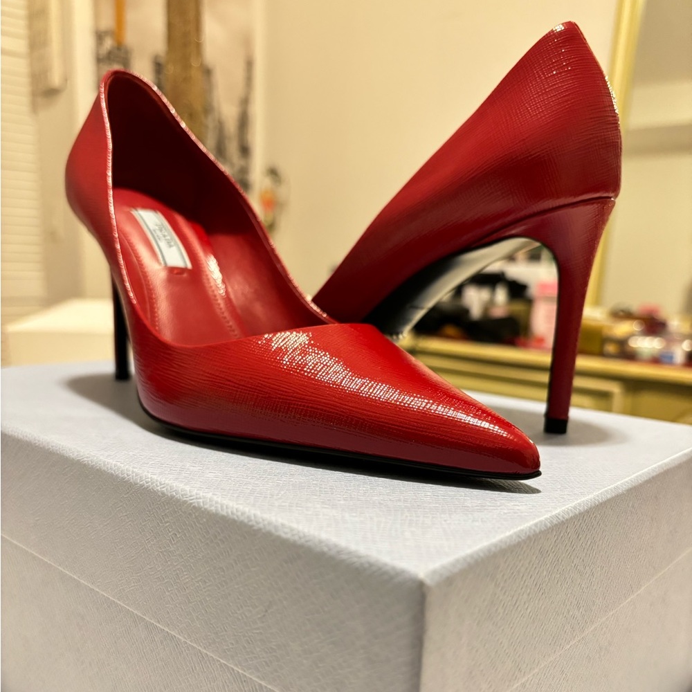Prada red heels covered toes.
